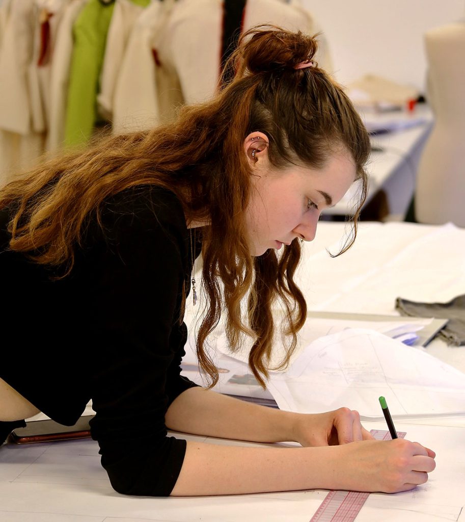 Marbella design academy charity cudeca fashion student working design desk - Marbella Design Academy