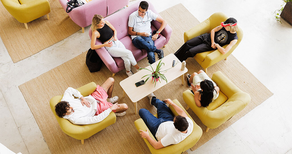 Marbella design academy facilities plaza students chatting sitting sofas - Marbella Design Academy