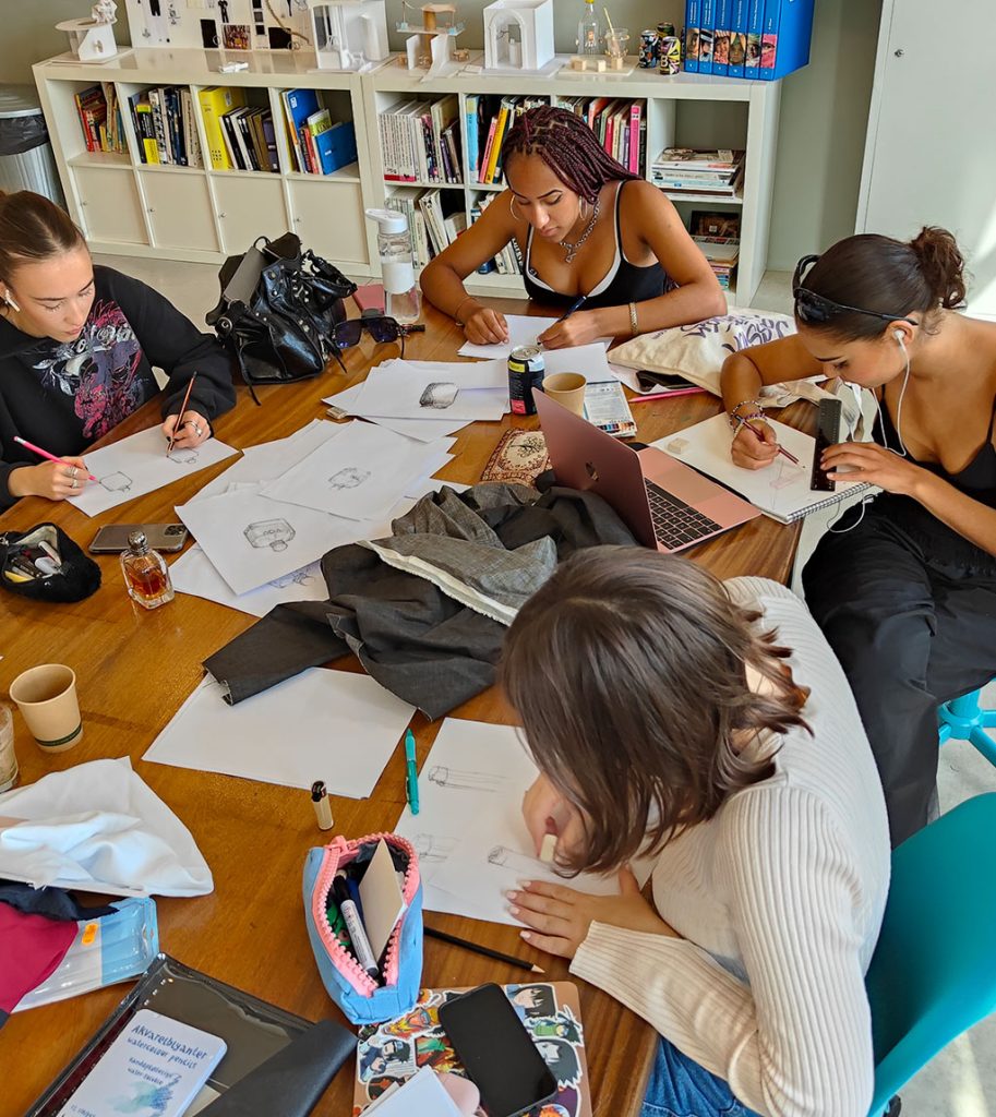 Marbella design academy study with us academic aims students wotking at desk foundation course - Marbella Design Academy